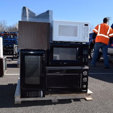 Pile of old TVs on a wooden pallet
