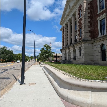 An image of the west side of City Hall, along Division Street North, showing the sidewalk.