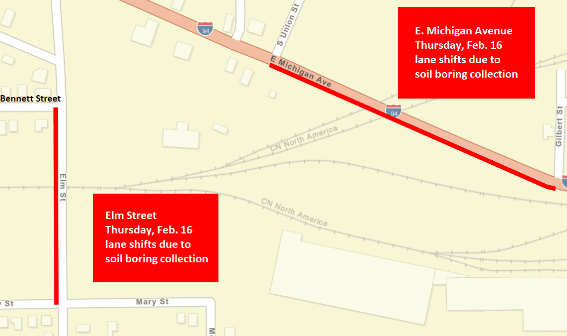 A city street map showing the E. Michigan Avenue and Elm Street lane shifts as red, solid lines.